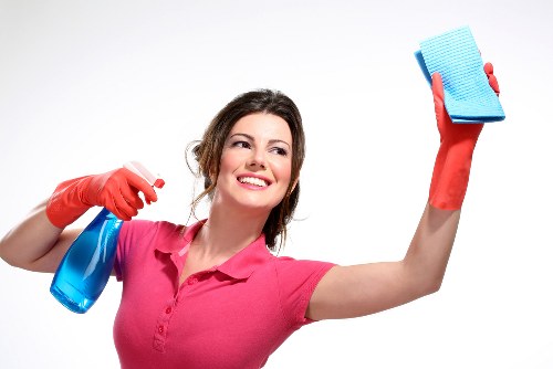 Local carpet cleaner treating stains in a Bow living room